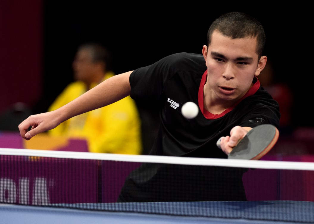 Male table tennis player prepares to return the ball