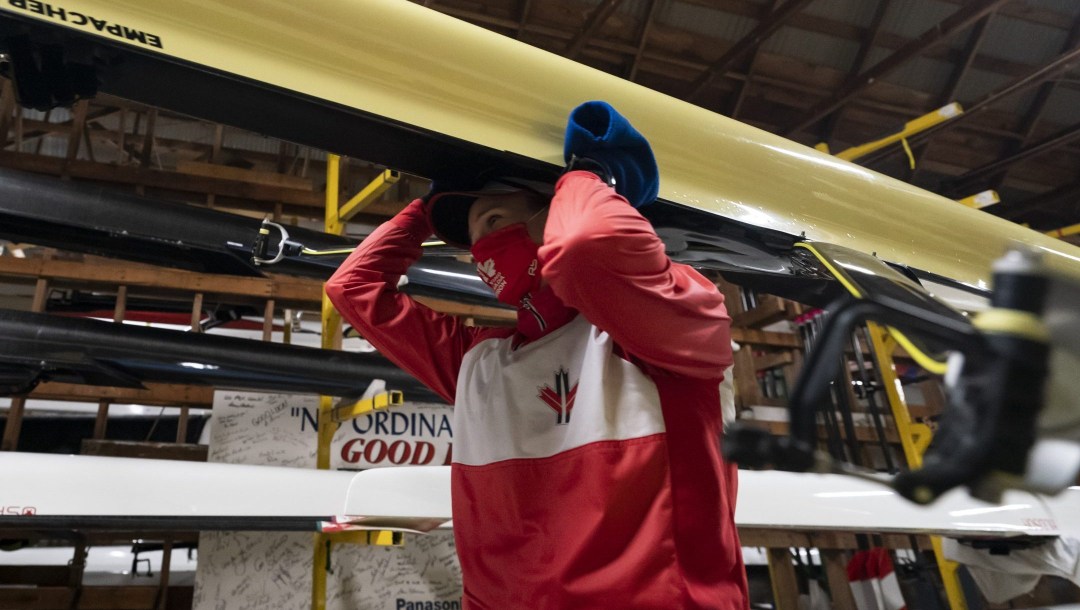 Canadian Olympic rower Carling Zeeman prepares to go out on the water at the Elk Lake training facility in Victoria, B.C., Wednesday, Dec. 9, 2020. The rowing facility which is home to national team members has employed Covid-19 protocols such as one-way walking lanes to the dock and boathouse, hand washing stations and a mask policy as athletes prepare for the rescheduled 2021 Tokyo Summer Olympics. THE CANADIAN PRESS/Jonathan Hayward