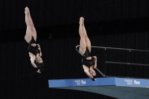 Canada's Meaghan Benefeito and Caeli McKay perform a dive during the women's synchronized 10-meter platform preliminaries at the FINA Diving World Cup Sunday, May 2, 2021, at the Tokyo Aquatics Centre in Tokyo. (AP Photo/Eugene Hoshiko)