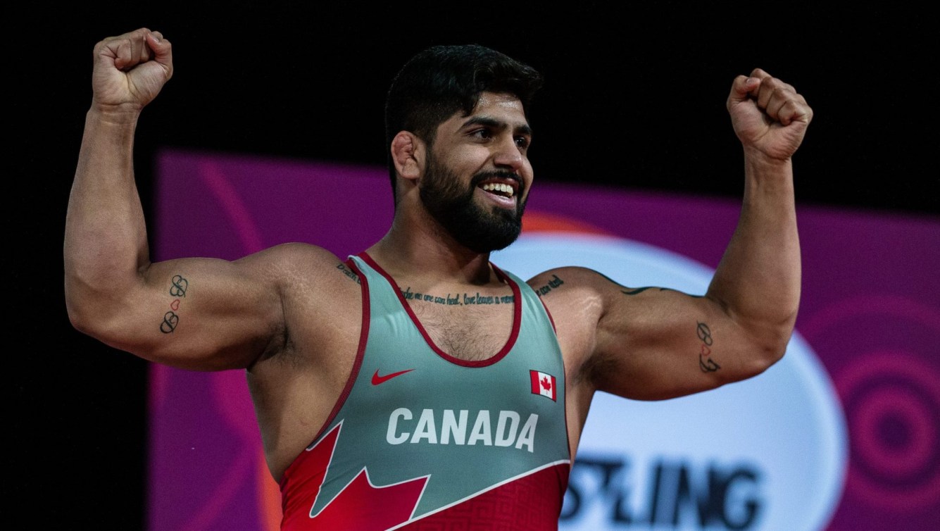 Amar Dhesi raises arms in celebration