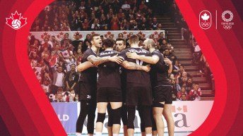 Men's volleyball players in a huddle