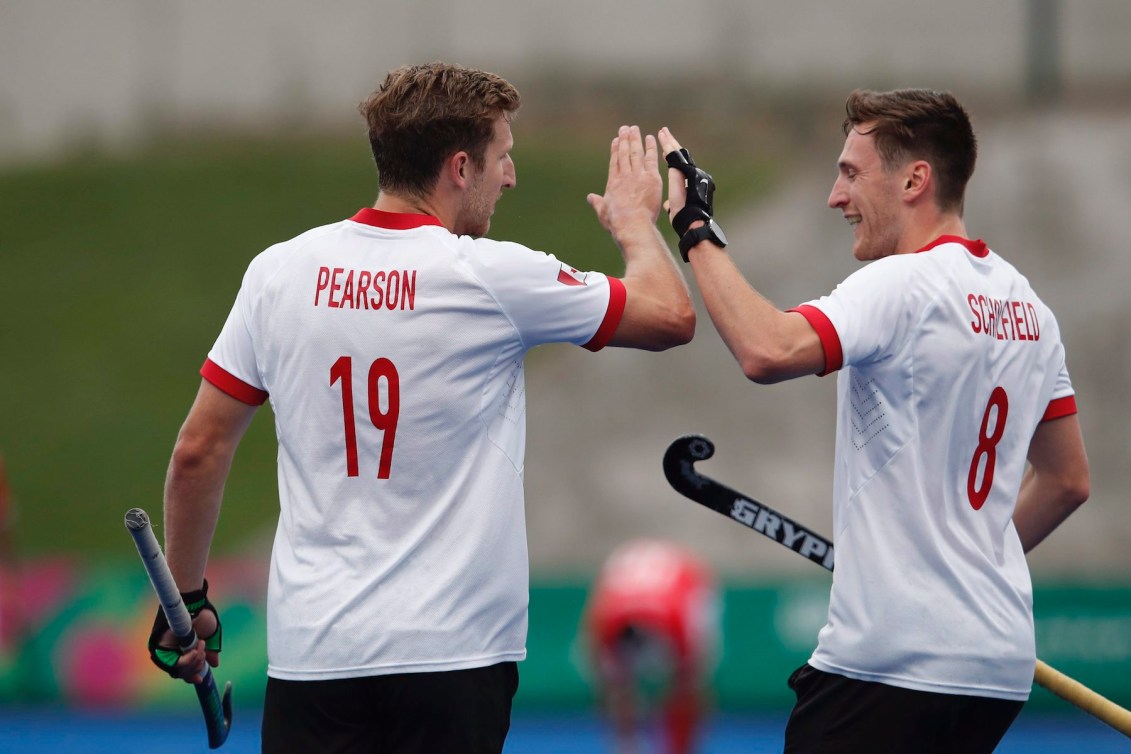 Canada's Mark Pearson, left, is congratulated by teammate Oliver Scholfield, after scoring against Mexico during a men's field hockey match at the Pan American Games in Lima, Peru, Tuesday, July 30, 2019. (AP Photo/Moises Castillo)