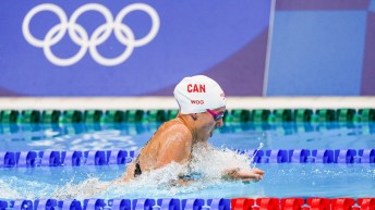 Kelsey Wog swims breaststroke in a race