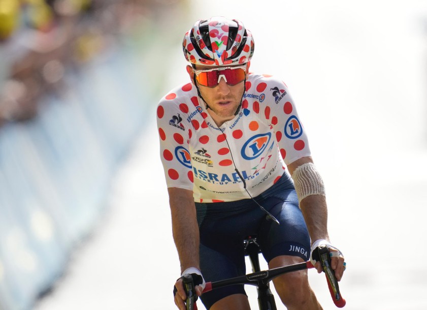 Michael Woods of Canada crosses the finish line after losing his best climber's dotted jersey to Netherland's Wouter Poels during the fifteenth stage of the Tour de France cycling race over 191.3 kilometers (118.9 miles) with start in Ceret and finish in Andorra-la-Vella, Andorra, Sunday, July 11, 2021. (AP Photo/Christophe Ena)