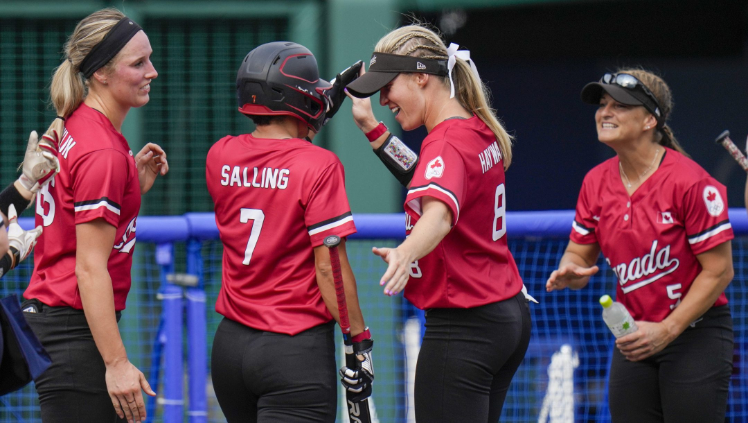 Canada's softball team celebrates after their 4-0 victory over Japan.
