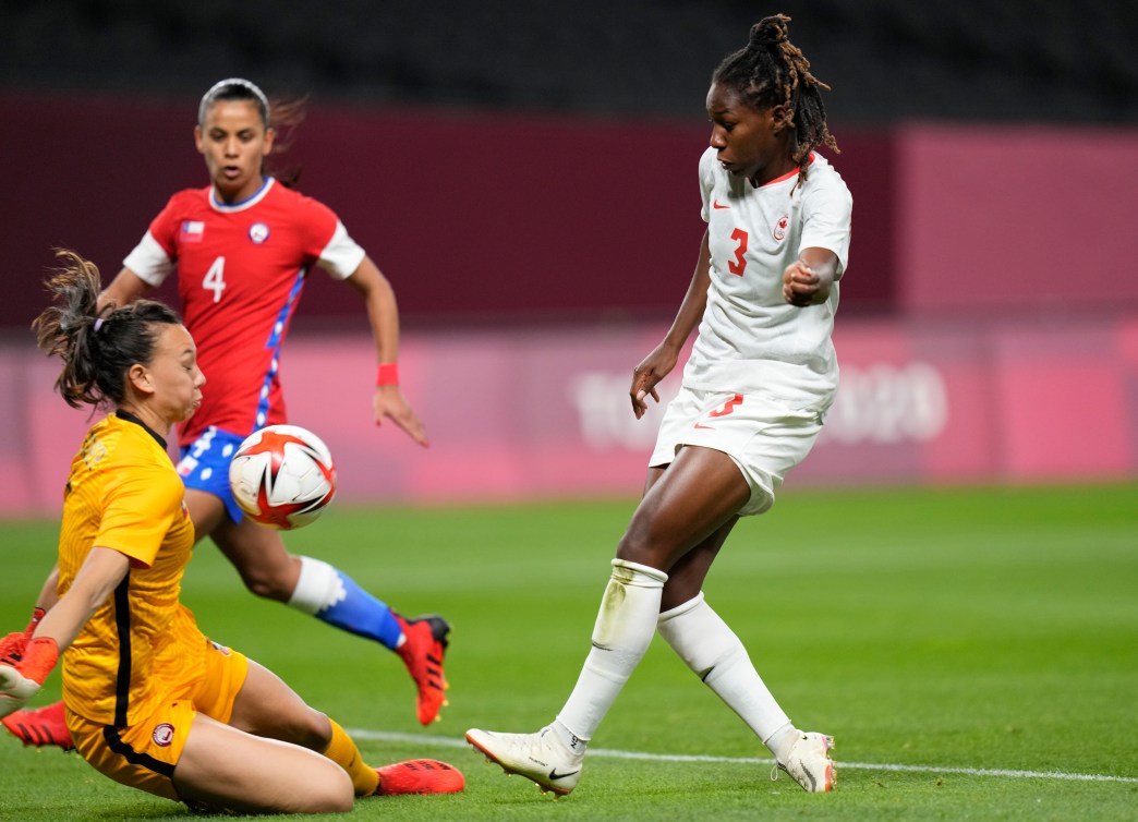 Kadeisha Buchanan of Canada kicks the ball into the chest of the Chile goalkeeper as she slides out to block it.