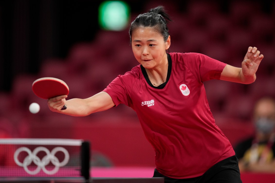 Canada's Zhang Mo competes during the table tennis women's singles third round match