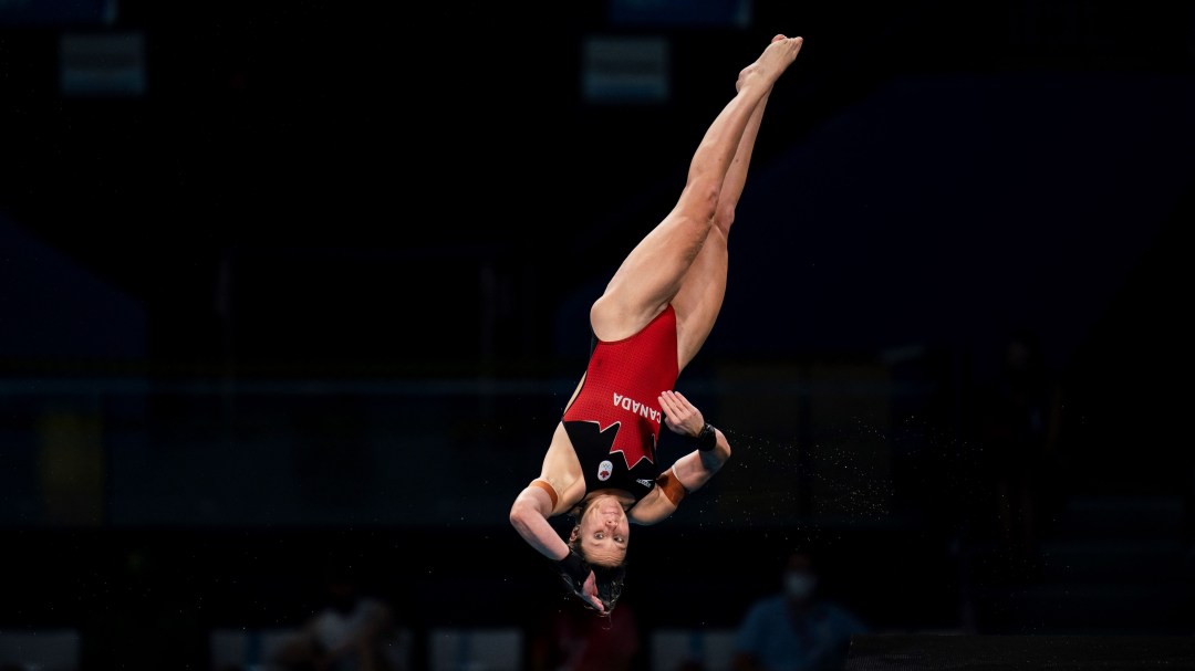 Celina Toth performs a twisting layout dive
