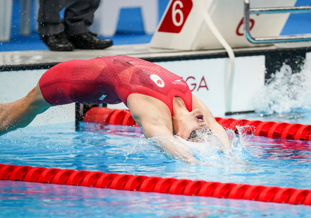 Kylie Masse dives in for start of 100m backstroke 