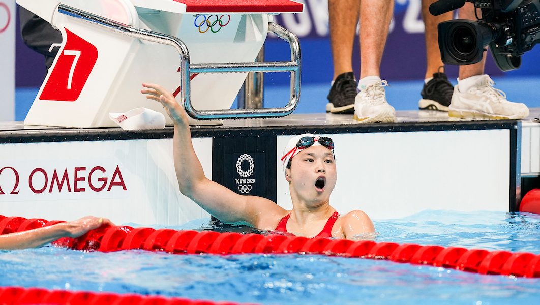 Maggie Mac Neil gasps at the result after winning gold