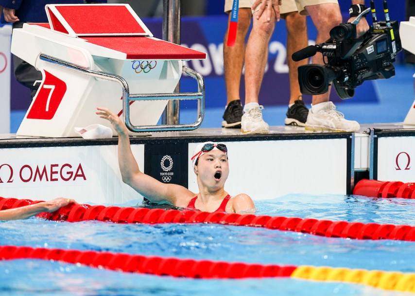 Maggie Mac Neil gasps at the result after winning gold