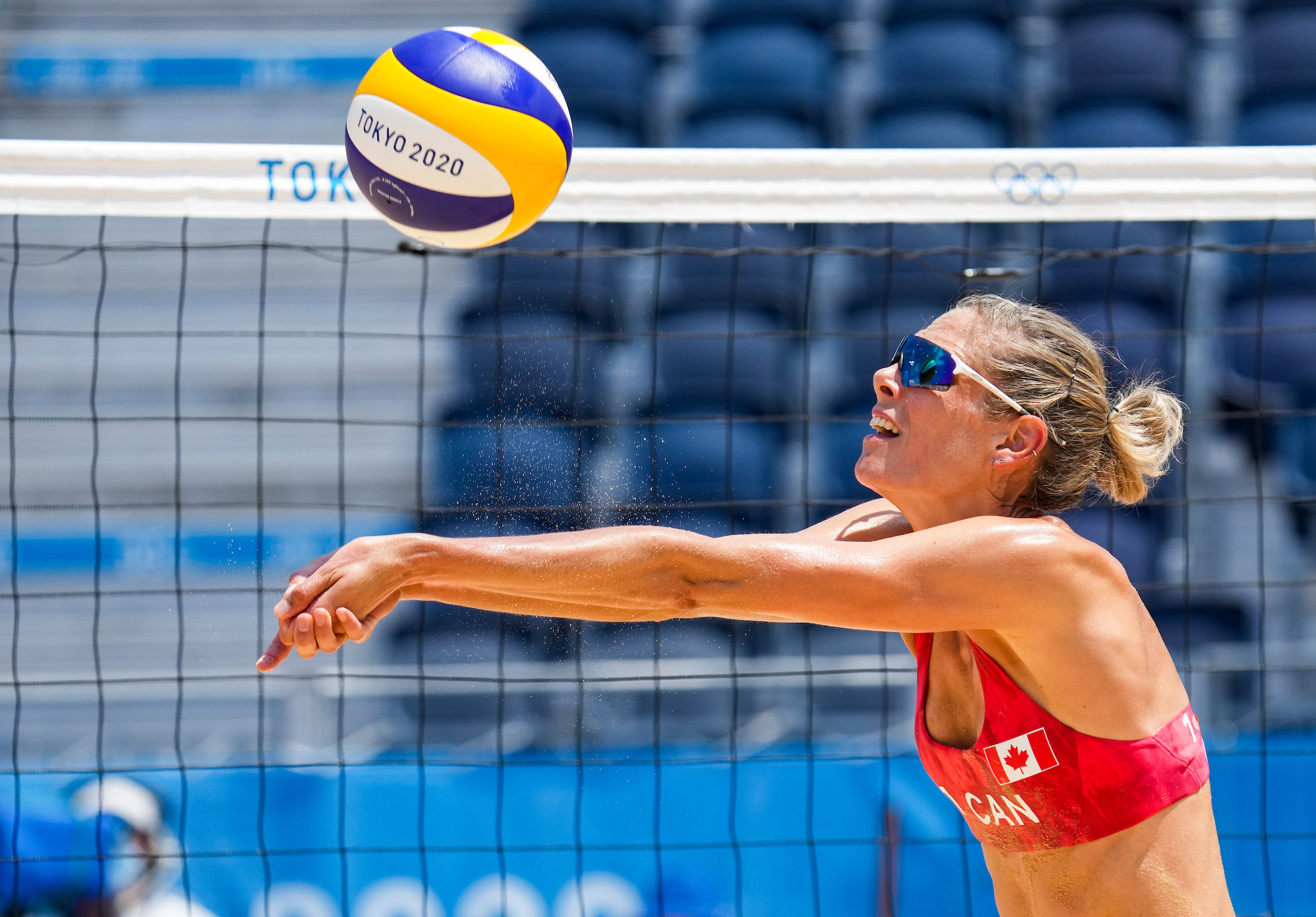 Beach volleyball player bumps a ball