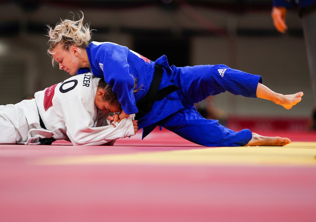 female athletes wrest on the mat during a match