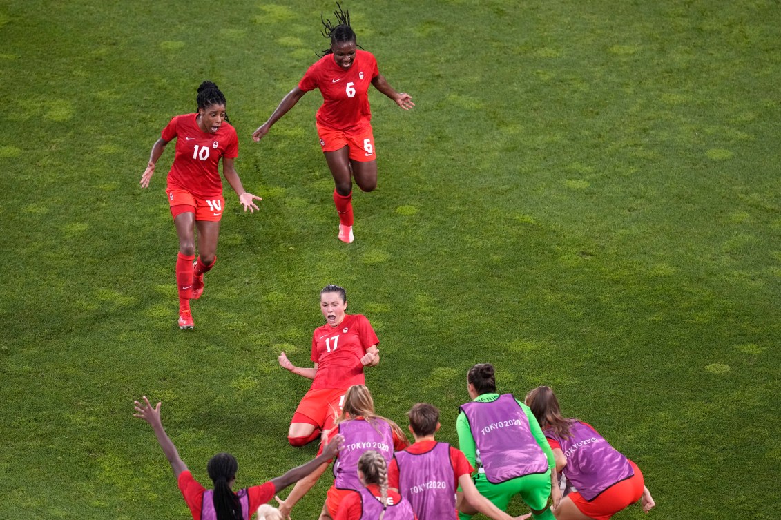 Jessie Fleming celebrates with teammates