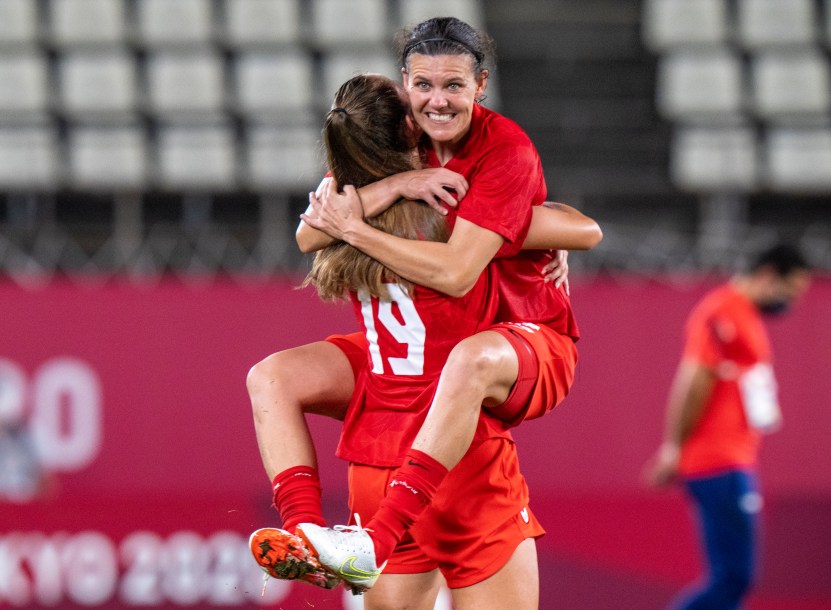 Christine Sinclair celebrates in teammate Jordyn Huitema's arms