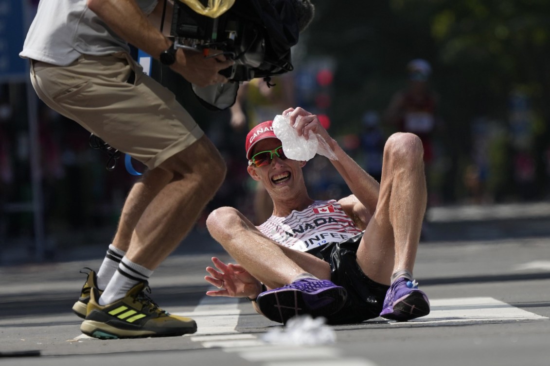 Evan Dunfee on the ground after winning bronze in the 50km race walk