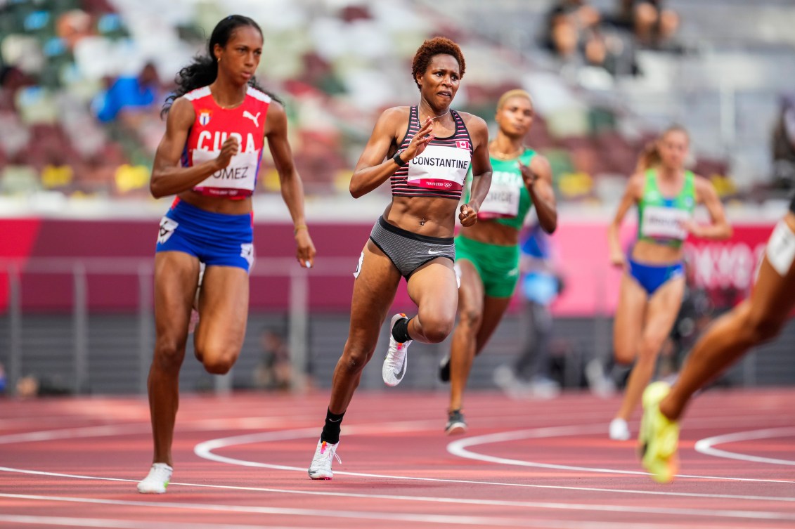 Kyra Constantine running on a track 