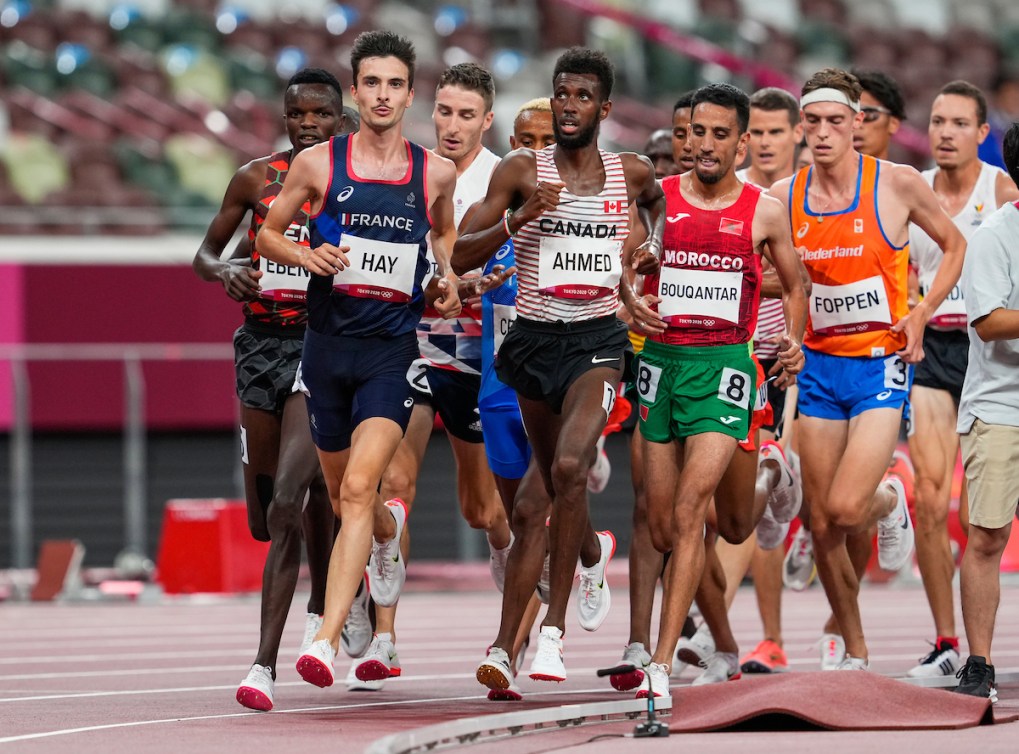 Mohammed Ahmed looks up at the board during the men's 5,000 metre qualification round.