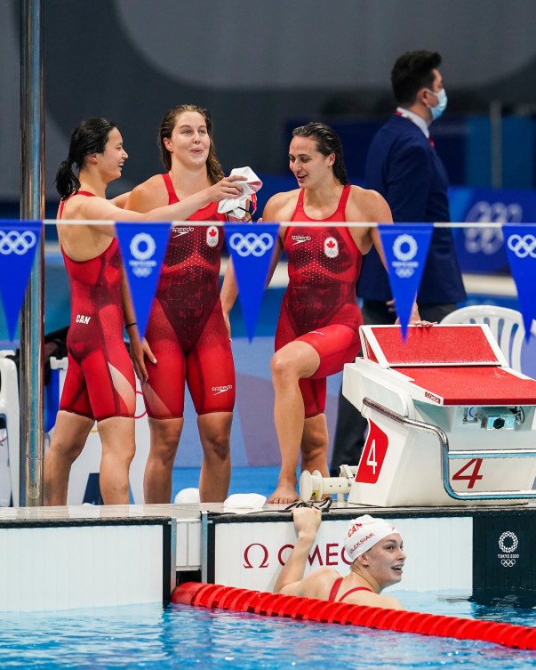 Canadian women's medley relay celebrates on pool deck 