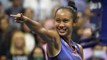 Leylah Fernandez points to fans in celebration after a win