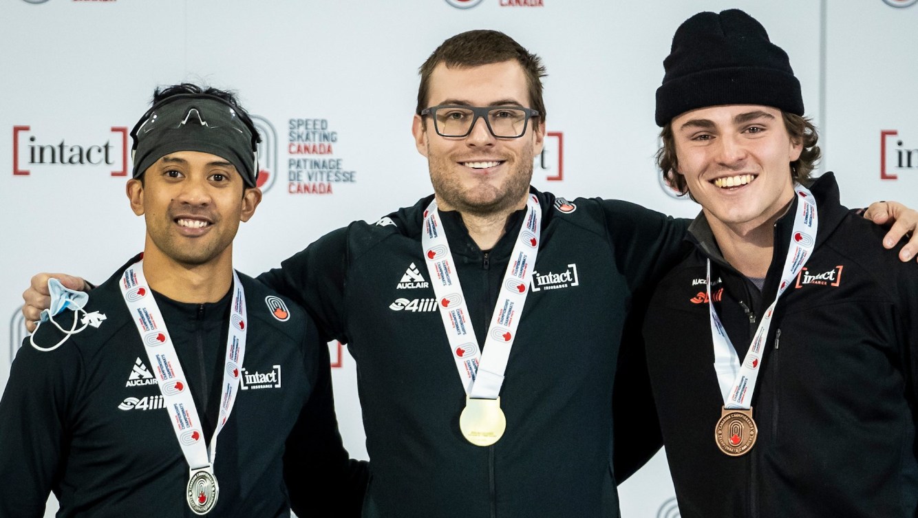 (L-R) Gilmore Junio, Laurent Dubreuil, and Cedrick Brunet stand on podium with medals around neck.