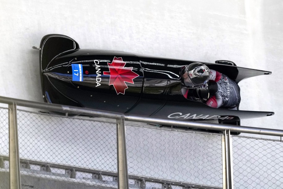 Two-woman bobsled goes around the curve of a track