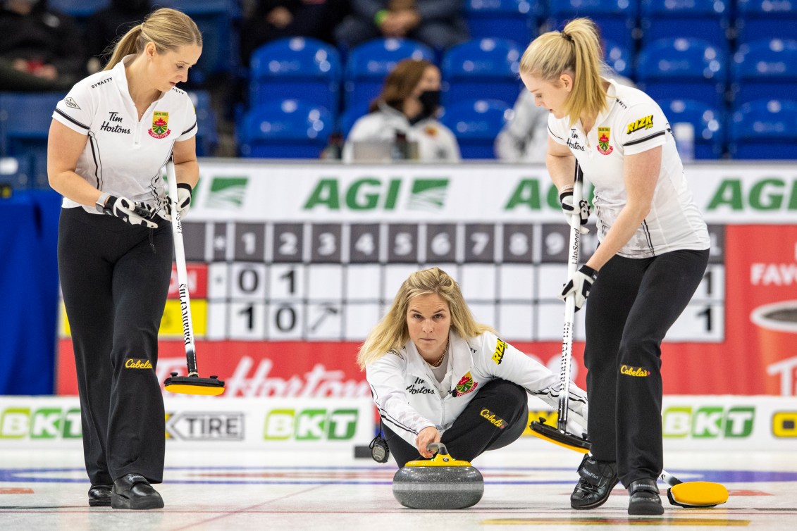 Jennifer Jones throws a rock from the house 