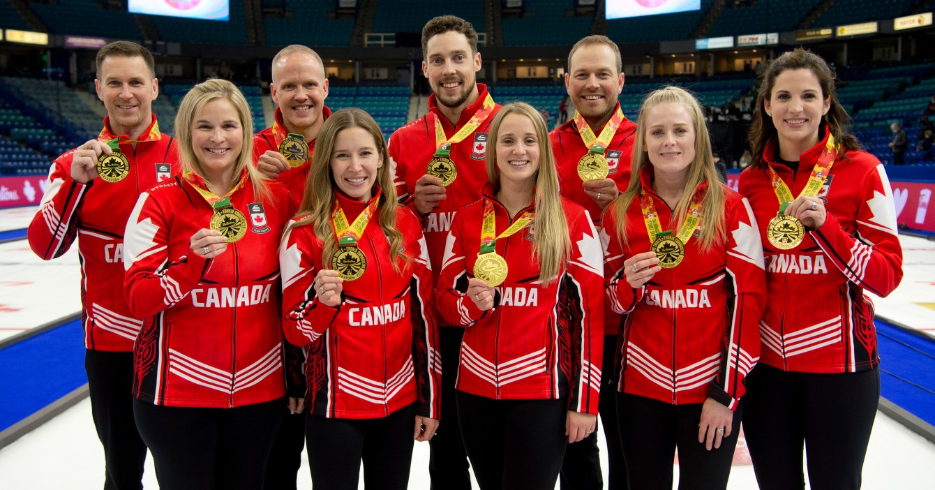 Canada's curling teams for Beijing 2022 pose with their medals 