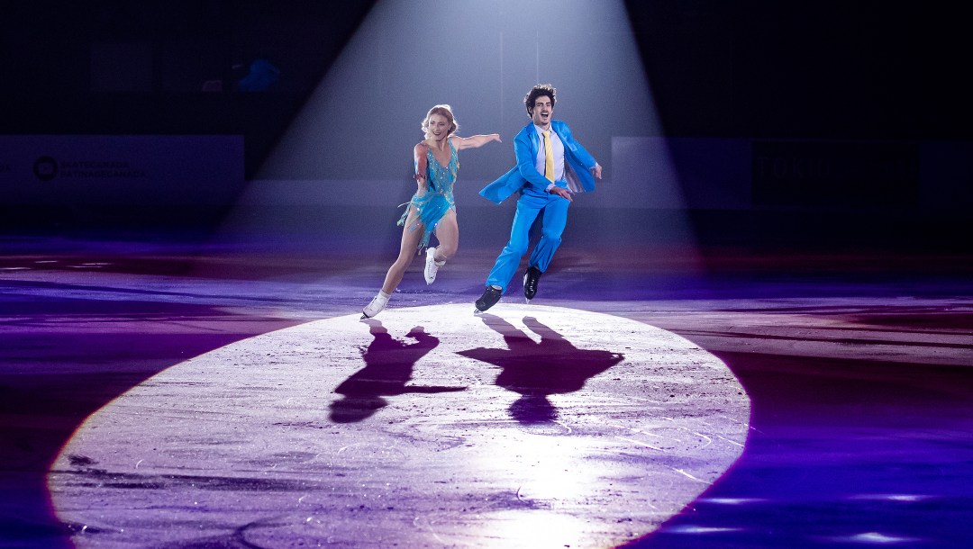 A spotlight shines on Piper Gilles (left) and Paul Poirier as they perform their gala routine.
