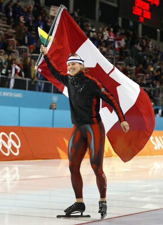 Catriona Le May Doan carries the Canadian flag on a victory lap at Salt Lake City 2002