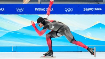 Side angle of Antoine Gelinas Beaulieu in full stride in speed skating race
