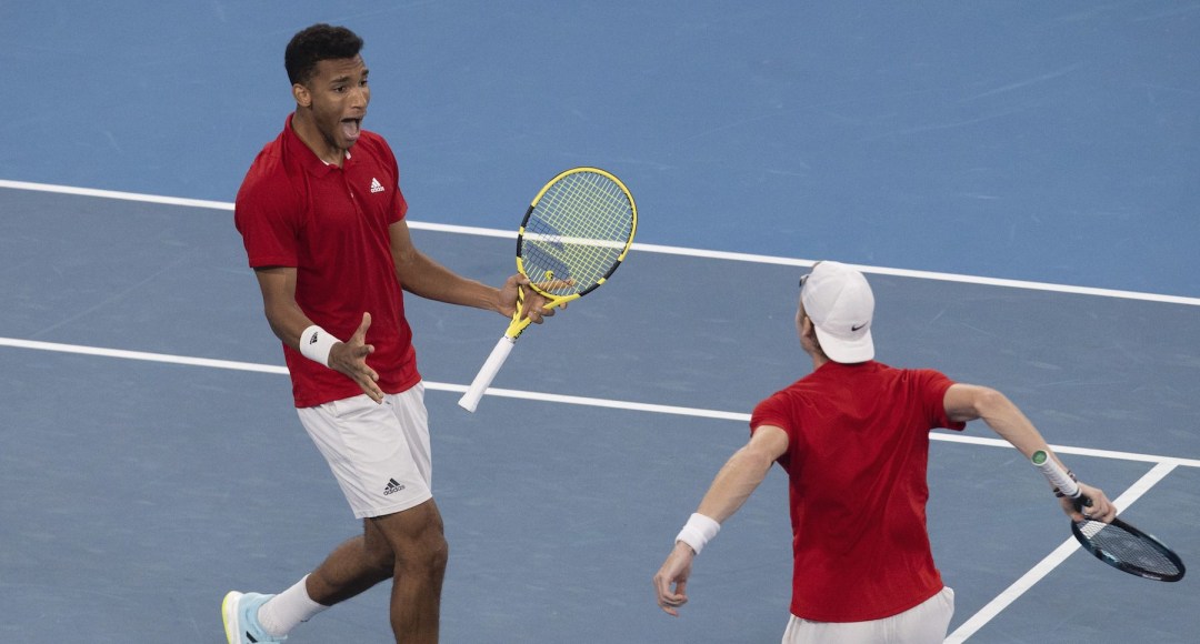 Felix Auger-Aliassime, left, and Denis Shapovalov of Canada react to winning their match against Russia's Daniil Medvedev and Roman Safiullin during their semifinal match at the ATP Cup tennis tournament in Sydney, Saturday, Jan. 8, 2022. (AP Photo/Steve Christo)