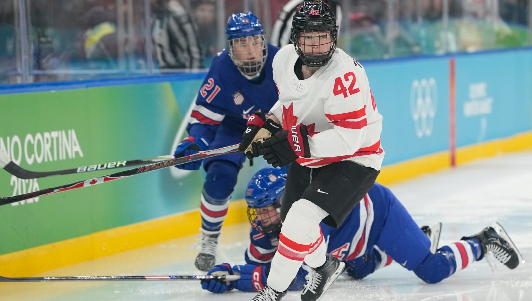 Claire Thompson competes in ice hockey.