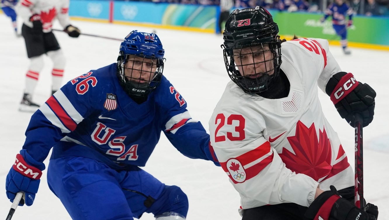 Erin Ambrose competes in ice hockey.