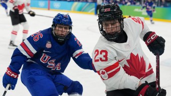 Erin Ambrose competes in ice hockey.