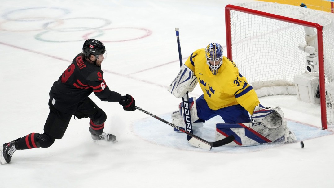 Corban Knight skates towards the Swedish goaltender who sticks his pad out to make a save