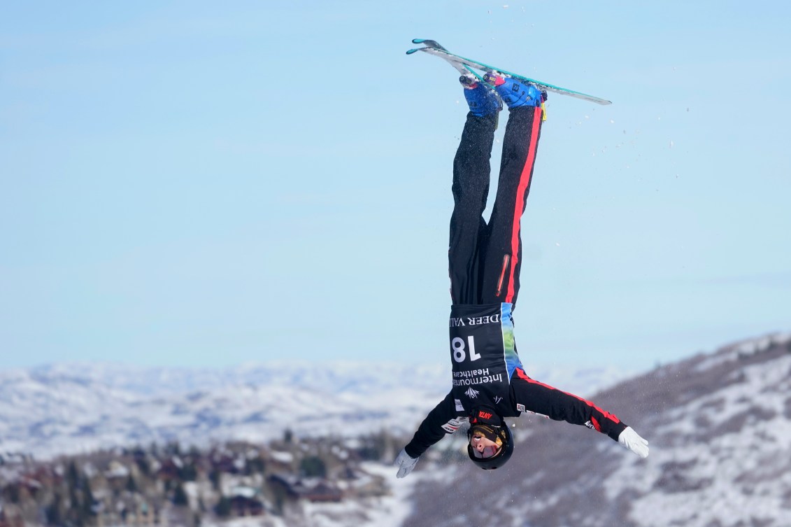 Emile Nadeau upside down in the air while competing in aerials 