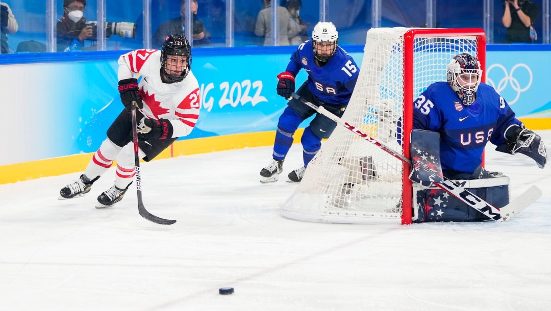 Emma Maltais chases the puck from out behind the American net