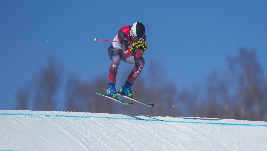 Jared Schmidt goes over a jump on a ski cross course