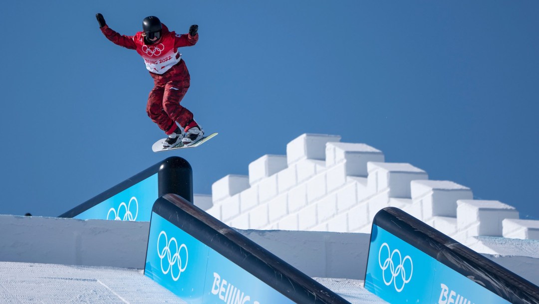 Jasmine Baird prepares to land on a rail in a snowboard slopestyle run