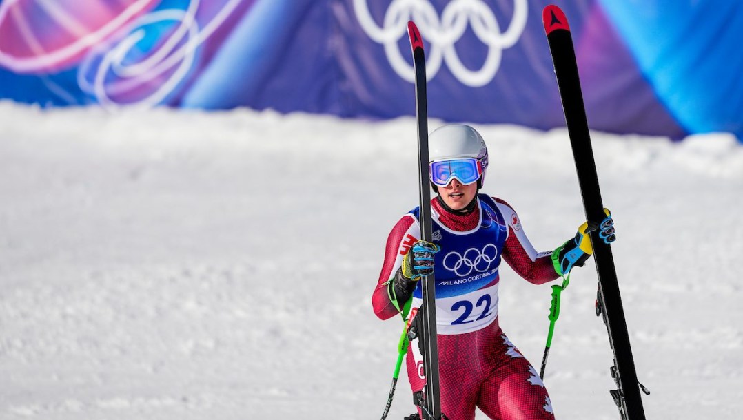 Brodie Seger holds his skis.