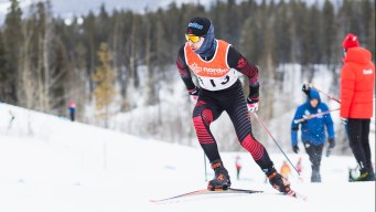 Male athlete is skiing during a cross country race.