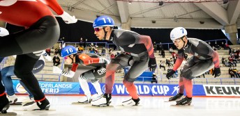 Low angle look at speed skaters in a mass start race