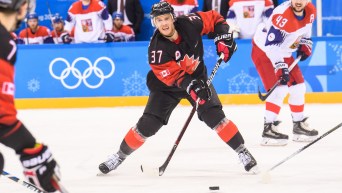 Canada defenseman Mat Robinson (37) makes a pass to Canada forward Gilbert Brule (7) during the third period of the Men's Ice Hockey Preliminary Round Group A game between Olympic Athletes from Czech Rebuplic and Canada at Gangneung Hockey Centre on February 17, 2018 in Gangneung, South Korea.