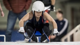 Natalie Corless pushes off the start in her luge sled