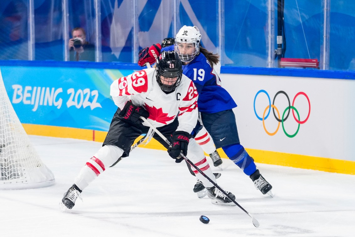 Marie-Philip Poulin #29 of Team Canada plays the puck against Jincy Dunne #19 of Team United States