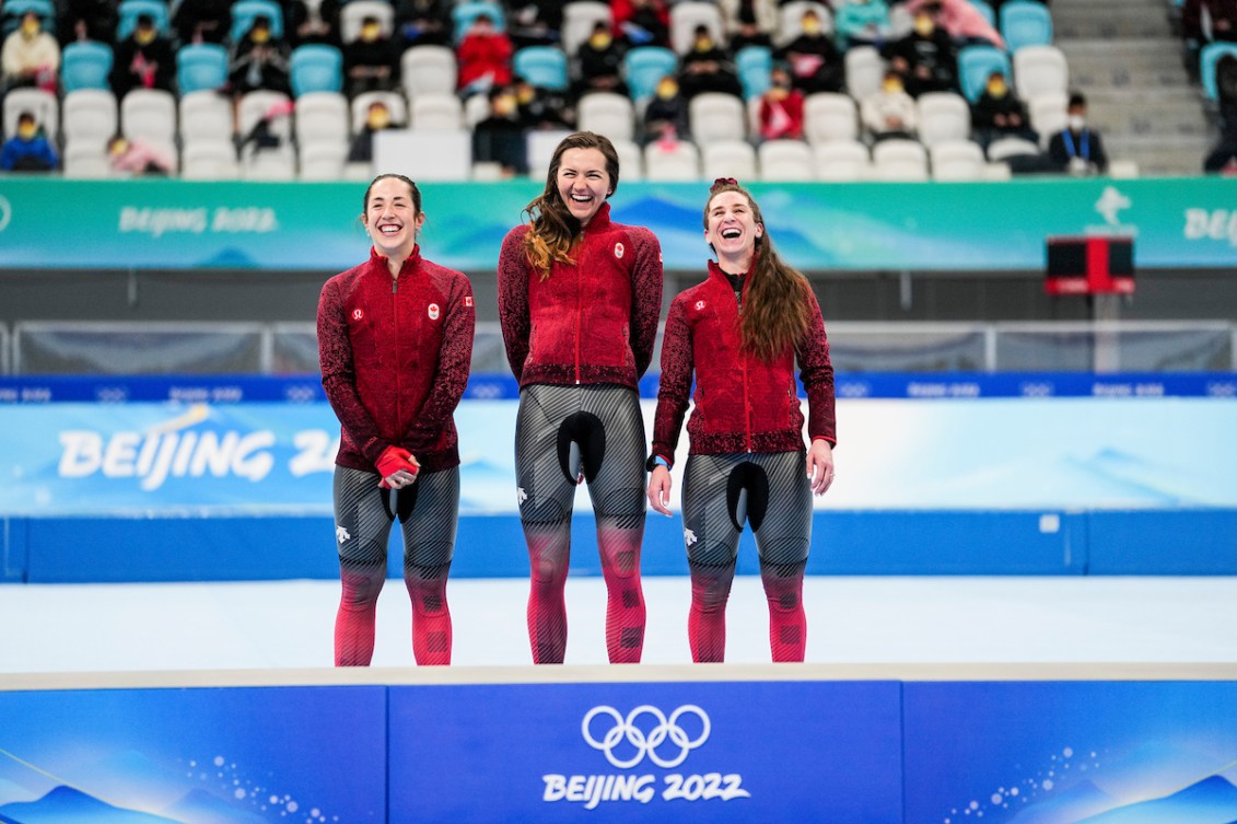Team Canada long track speed skaters Ivanie Blondin, Valerie Maltais and Isabelle Weidemann celebrate their gold medal