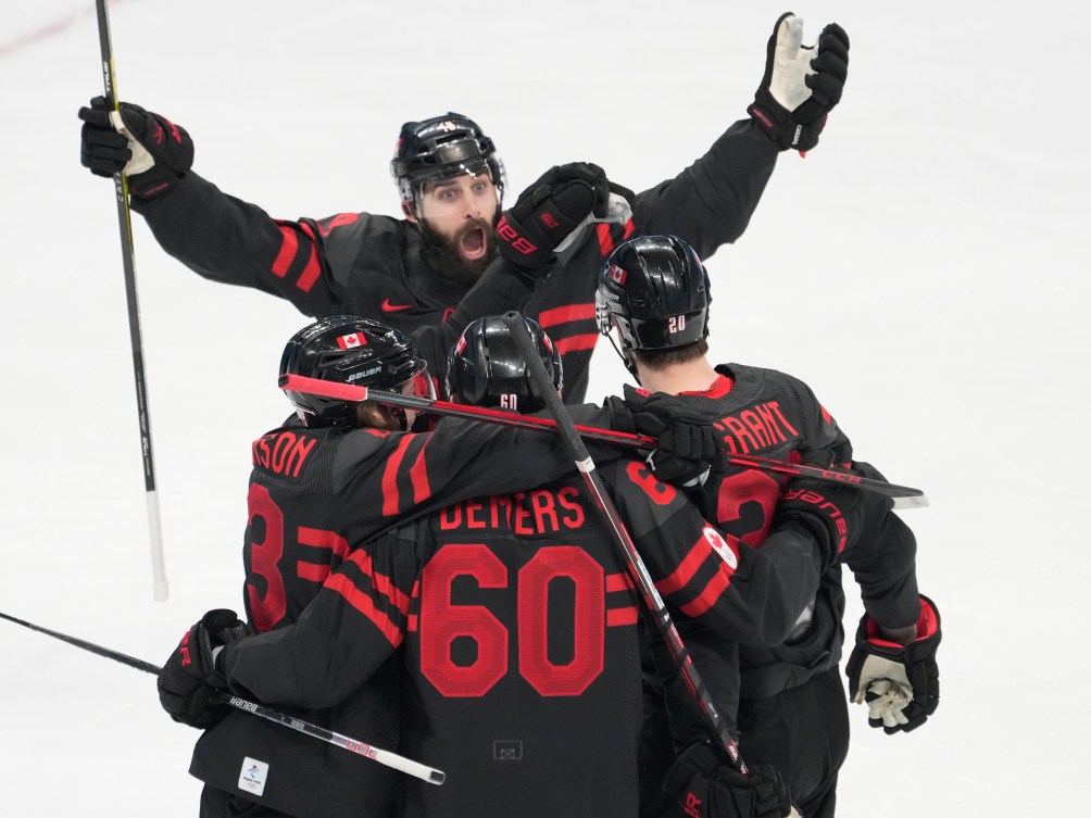 Canada players celebrate a goal by Alex Grant at Beijing 2022