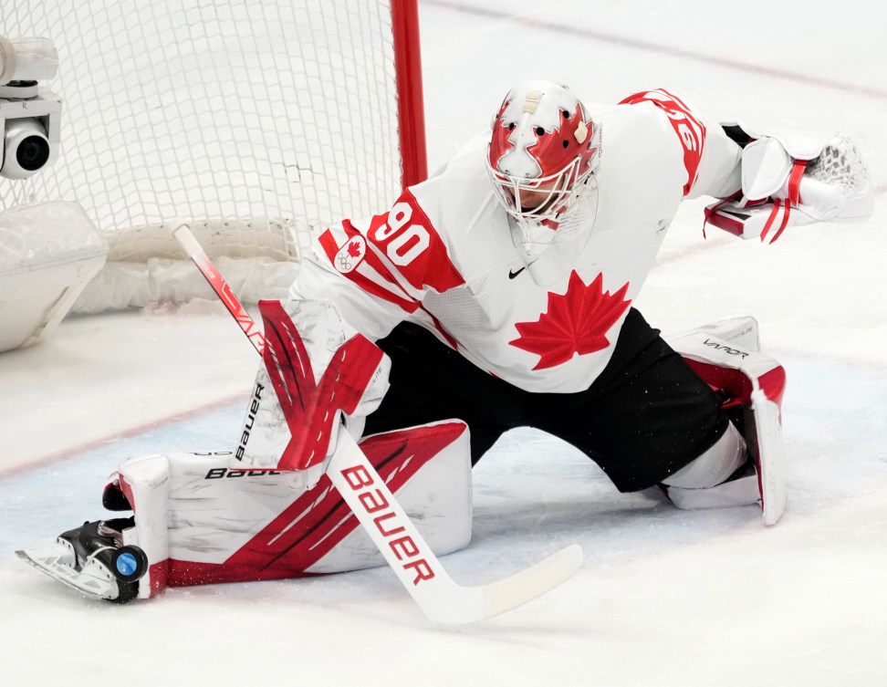 Team Canada goaltender Matt Tomkins (90) makes a save