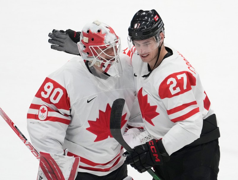 Canada forward Adam Cracknell (27) congratulates Canada goaltender Matt Tomkins (90)